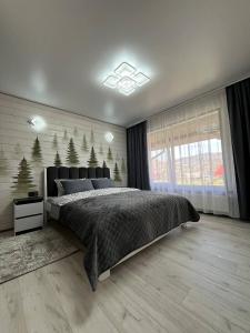 Postel nebo postele na pokoji v ubytování Котеджі Мелодія Карпат