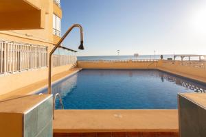 a swimming pool on the side of a building at El Paraíso Dorado in Bellreguart