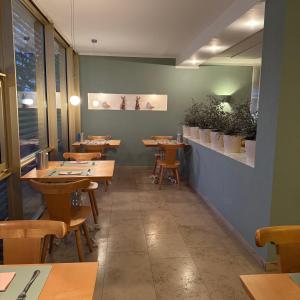 a dining room with wooden tables and chairs at Hotel Milú in Ludwigsburg +19 photos