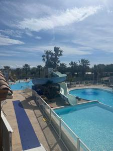 a slide in a pool at a resort at Mobil'home à Torreilles Plage in Torreilles