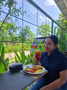 a woman sitting at a table with a plate of food at Guest House d Valeri in Labuan Bajo +34 photos