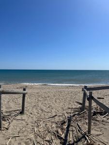 a beach with two wooden fences and the ocean at Mobil'home à Torreilles Plage in Torreilles +4 photos