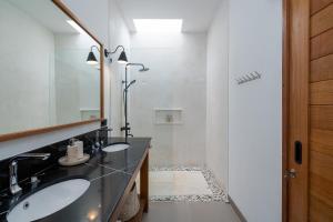a bathroom with two sinks and a mirror at Villa Le Blanc - Tropical Luxury 3BR Villa with Pool & Rooftop Views in Tumbak Bayuh in Tumbak Bayuh