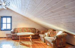 a living room with two couches and a table at Amazing Home In Jøsenfjorden With Sauna in Gullingen