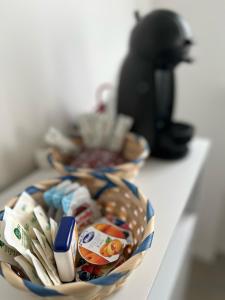 a bowl of toiletries on a counter with another bowl at Suite Tra il Centro e il Mare,Vicino Stazione in Savona