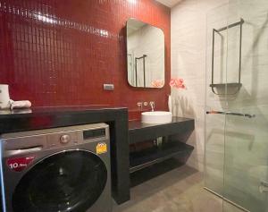 a bathroom with a washing machine and a sink at UTrip # EDGE CENTRAL PATTAYA in Pattaya Central +64 photos