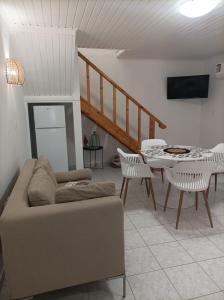 a living room with a couch and a table at Petrochori Memories Maisonette in Petrochori