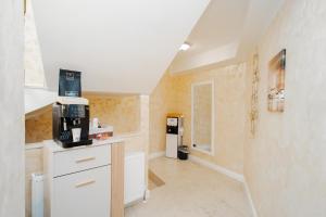 a kitchen with a stairway with a coffee maker at Boutique Hotel Palas 500m Walking Distance in Iaşi