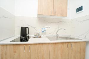 a kitchen with a sink and a coffee maker on the counter at Boutique Hotel Palas 500m Walking Distance in Iaşi +16 photos