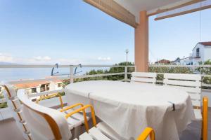 a table and chairs on a balcony with a view of the water at Apartment Jenul in Labin
