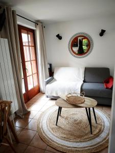 a living room with a couch and a table at Studio vue montagnes RDC piscine in Cauterets