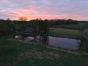 an aerial view of a pond in a field at Lotus Hütte in Eggermühlen