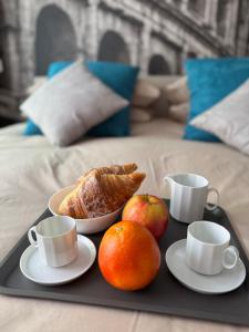 a tray with breakfast foods on a bed at Labicum XXII - Modern Luxury Studio near the Colosseum in Rome +31 photos