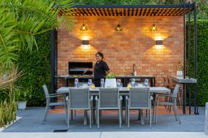 a woman standing in front of a brick wall at 4 Bed Sea View Villa with Breakfast - KBR32 in Ban Bang Po