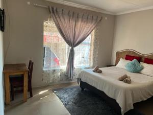 a bedroom with a bed with two teddy bears on it at AS contractors accommodation in Erasmus