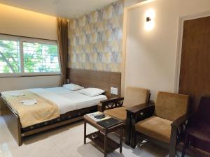 Postel nebo postele na pokoji v ubytování Hotel Shreyas