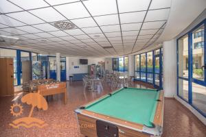 a pool table in a room with tables and chairs at Patacona Resort Apartments Primera Linea in Valencia