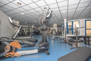 a gym with several treadmills and cardio machines at Patacona Resort Apartments Primera Linea in Valencia