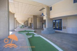 a hallway of a building with a green floor at Patacona Resort Apartments Primera Linea in Valencia