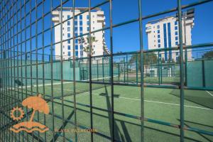 a view of a tennis court through a fence at Patacona Resort Apartments Primera Linea in Valencia