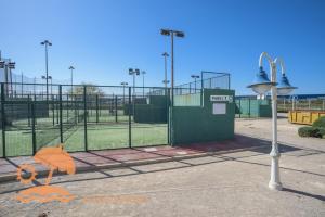 a batting cage with an umbrella in a batting cage at Patacona Resort Apartments Primera Linea in Valencia