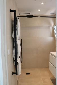 a closet with white towels hanging on the wall at Splendid 3-bedroom villa for 6 people in Saint-Tropez