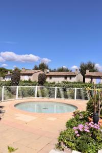 a swimming pool in a yard with a white fence at Splendid 3-bedroom villa for 6 people in Saint-Tropez