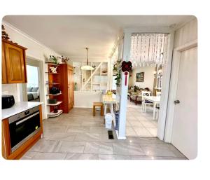 a kitchen and living room with a table in it at Jalynn 1 Cottage in Glen Waverley