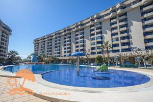 an empty swimming pool in front of a large building at Patacona Resort Apartments Primera Linea in Valencia