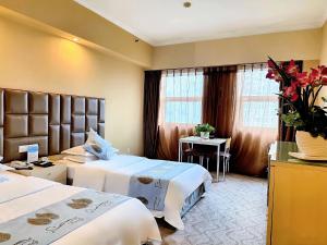 Postel nebo postele na pokoji v ubytování Chongqing Milky Way Hotel