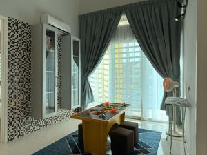 a living room with a table in front of a window at Fairy 2 Pool Villa 22 Pax Karaoke & Huge Event Space in Ipoh
