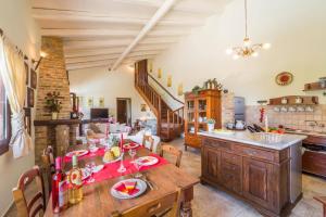 a kitchen and dining room with a wooden table at Villa Adonis by Villa Plus in Agnítsini