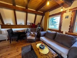 a living room with a couch and a table at Vila Šarigora in Žabljak
