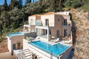 an aerial view of a house with a swimming pool at Villa Alena by Villa Plus in Kalami