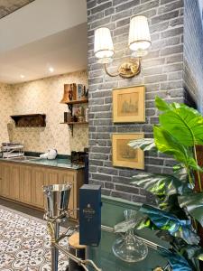 a restaurant with a brick wall and a counter at Nara Poshtel Sathorn in Bangkok