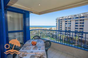 a balcony with a table and a view of the ocean at Patacona Resort Apartments Primera Linea in Valencia
