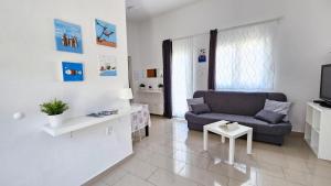 a living room with a couch and a tv at Apartments Šolta in Rogač