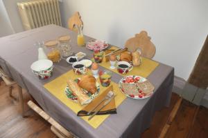 a table with a table cloth with food on it at Chambres d'Hôtes Colibri in Arthez-de-Béarn