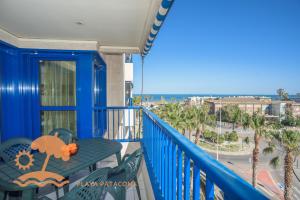 a balcony with a table and chairs and the ocean at Patacona Resort Apartments Primera Linea in Valencia