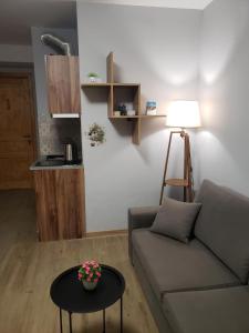 a living room with a couch and a table at Bakuriani - Didveli Gallery, B 203 in Bakuriani