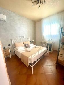 a bedroom with a white bed and a window at Il Cortile in San Vito lo Capo +18 photos