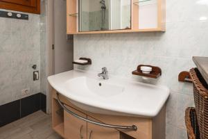 a bathroom with a white sink and a mirror at Affittacamere - L'ancora in Stintino +27 photos