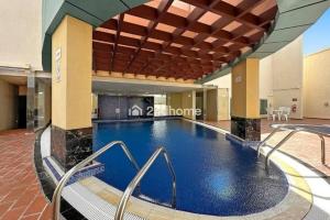 a large swimming pool in a large building at Luxury Unit Located in Icon Tower, JLT in Dubai