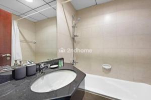 a bathroom with a sink and a shower at Luxury Unit Located in Icon Tower, JLT in Dubai