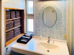 a bathroom with a sink and a mirror and towels at Ocean Terrace金武 in Kin +127 photos