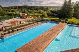 an overhead view of a swimming pool with a playground at Apartmán Frymburk in Frymburk