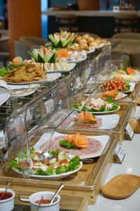 a buffet with many plates of food on a table at Rosaleen Boutique Hotel in Hue