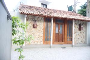 a small stone building with a wooden door at Handagedara Resort & Spa in Mirissa