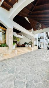 a building with a stone floor and a large patio at Bayahibe Paraíso in Bayahibe +4 photos