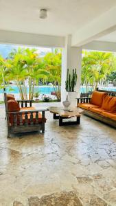 a living room with orange couches and a table at Bayahibe Paraíso in Bayahibe